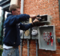 Electrician installing outdoor connections on multifamily house-859-229-641-564 Electrician installing outdoor connections on multifamily house-859-229-641-564